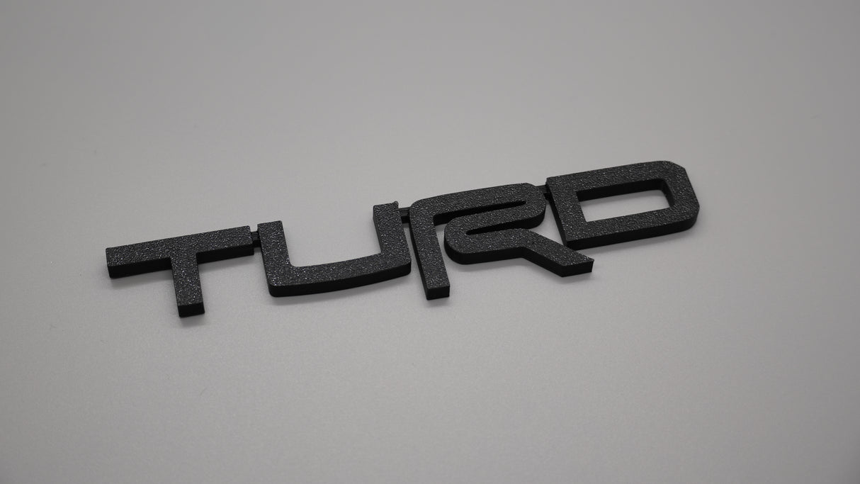Toyota Turd Badge