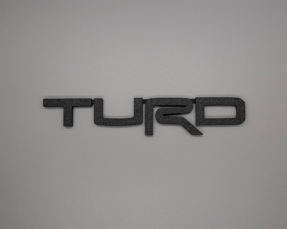 Toyota Turd Badge