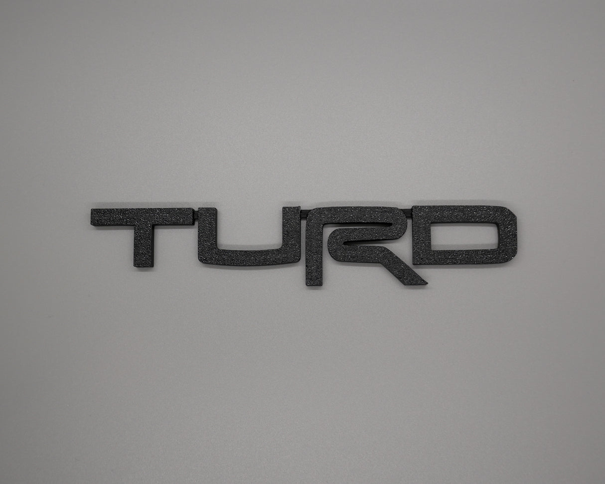 Toyota Turd Badge